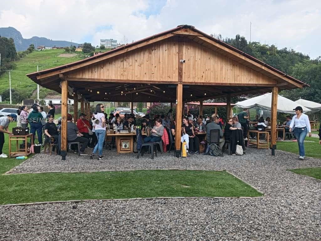 Spacious covered gathering area designed to accommodate larger groups and ensure comfortable use during rain or changing weather.