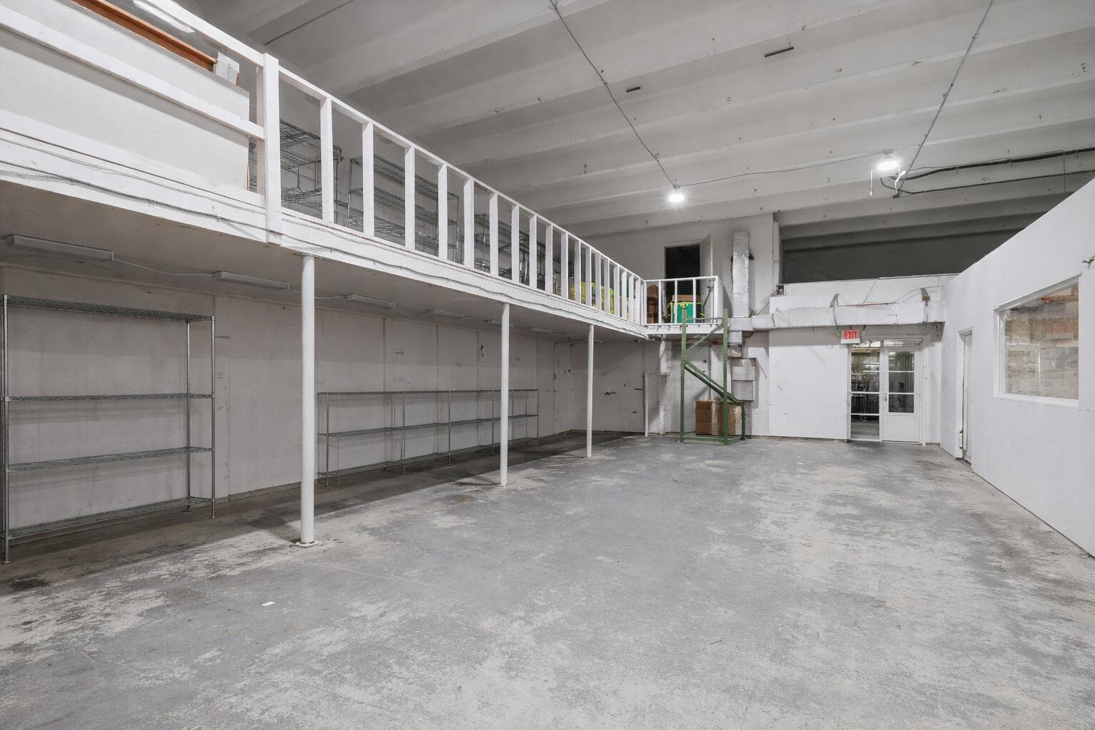 Empty warehouse with mezzanine shelving